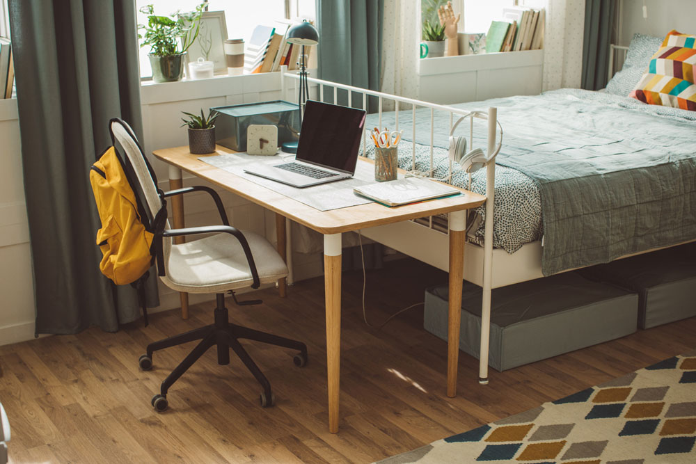Tidy university dorm room with study setup
