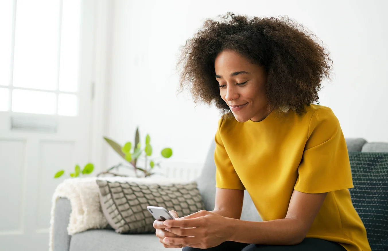 Woman using smartphone to start online ADHD self-assessment