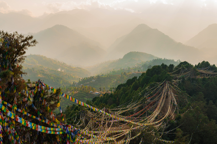 Prayer flags strung along the Everest Base Camp trail with Himalayan peaks in the background
