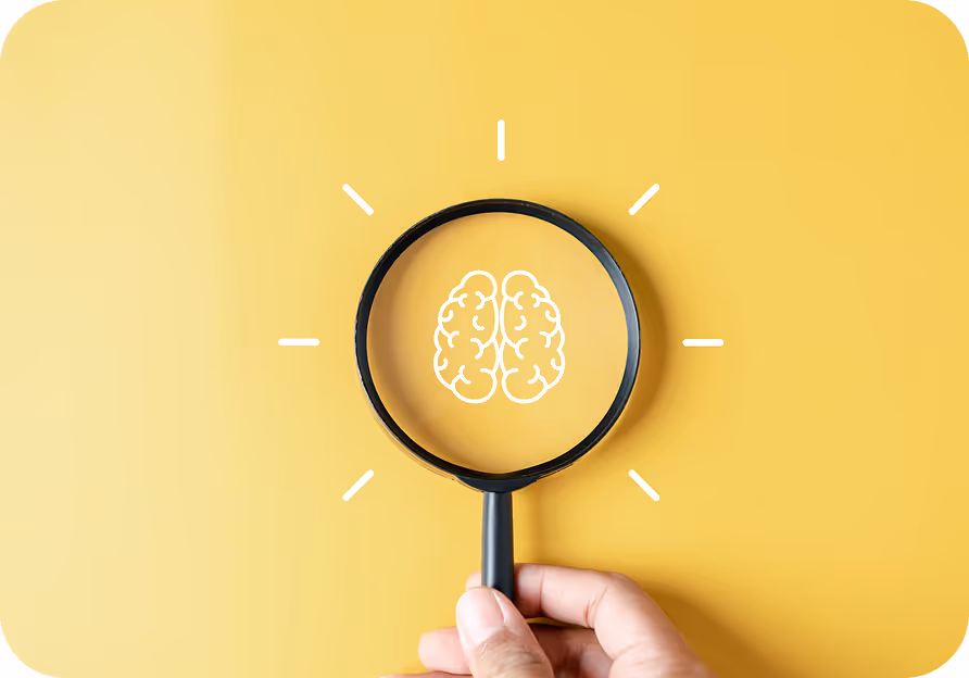 Illustration of a brain held inside a magnifying glass on a yellow background, representing exploring and learning about ADHD